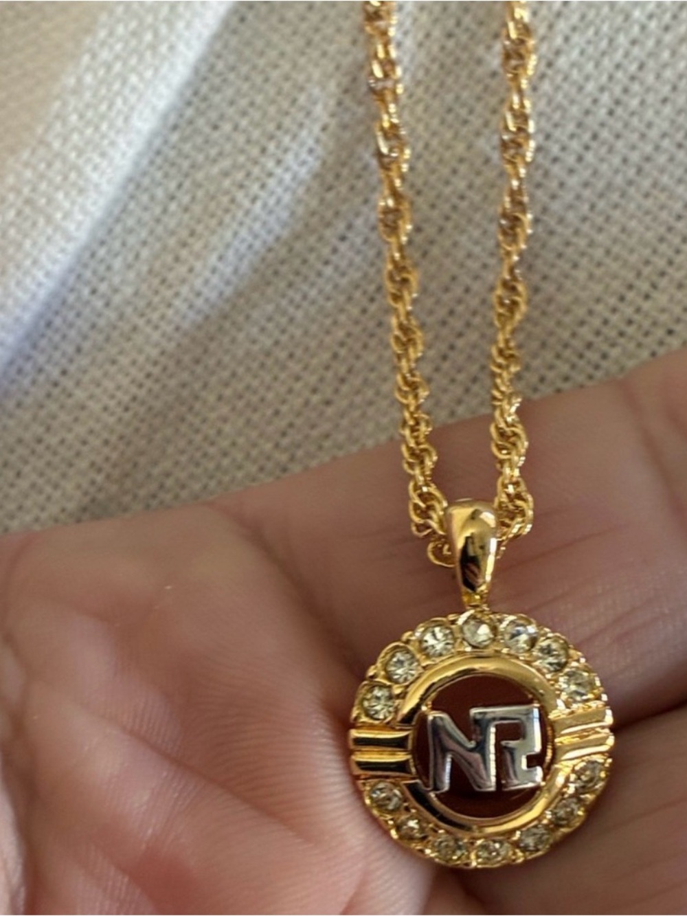 Nina Ricci Gold-Tone Crystal Round Pendant Necklace with Silver Initial Accent